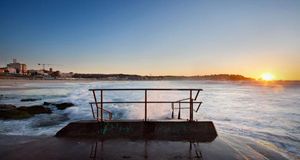 Sunrise on Bondi Beach in Sydney, Australia with a handrail in foreground (© Pawel Papis / Getty Images) &copy; (Bing Australia)