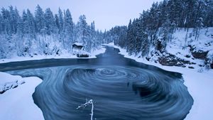 The whirlpool in Myllykoski scenic area at winter in Oulanka National Park, Kuusamo, Finland (© Lassi Rautiainen/Minden Pictures)(Bing Australia)