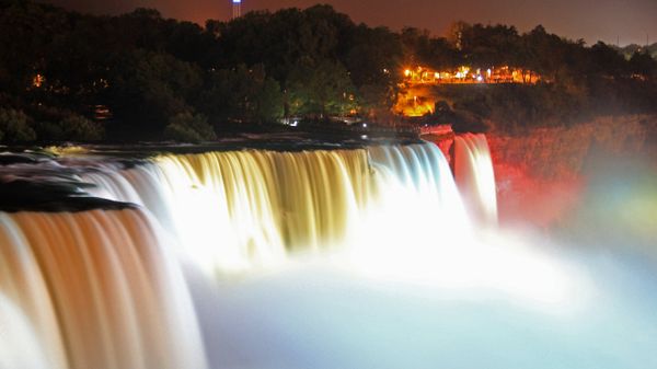 Illuminated American Falls, part of Niagara Falls, seen from the Prospect Point Park observation tower in Niagara Falls, New York