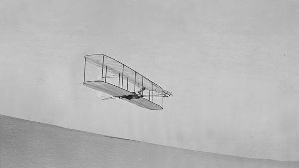 Wilbur Wright gliding down Big Kill Devil Hill in Kitty Hawk, North Carolina