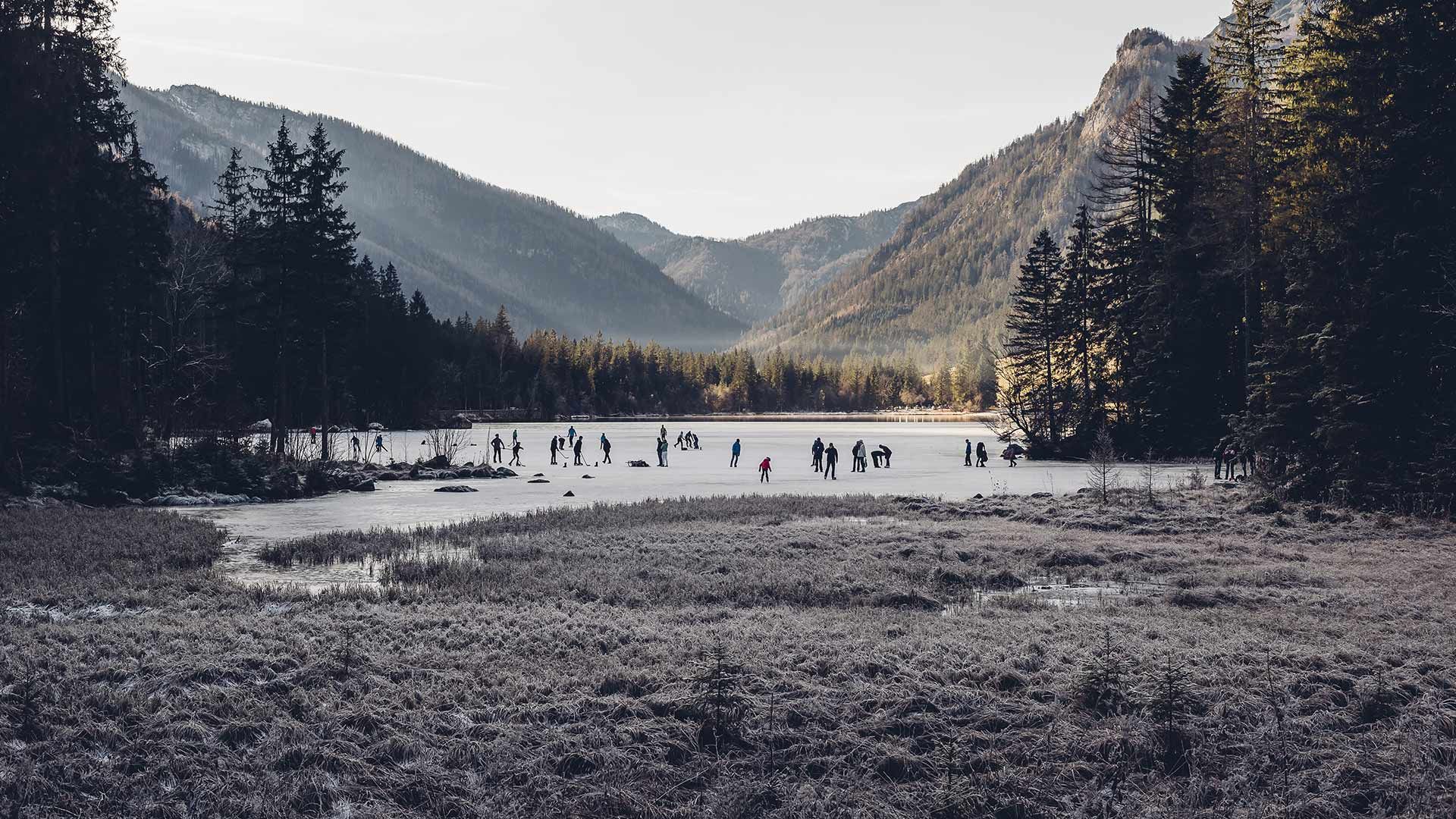 Ice skaters on Hintersee, a lake in Ramsau, Berchtesgadener Land, Bavaria, Germany