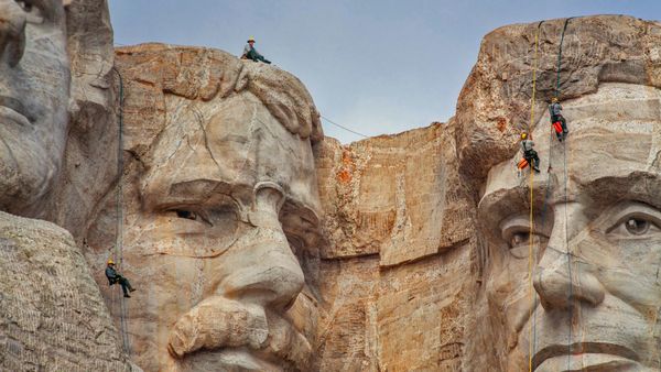 Park service employees inspecting Mount Rushmore National Memorial, South Dakota