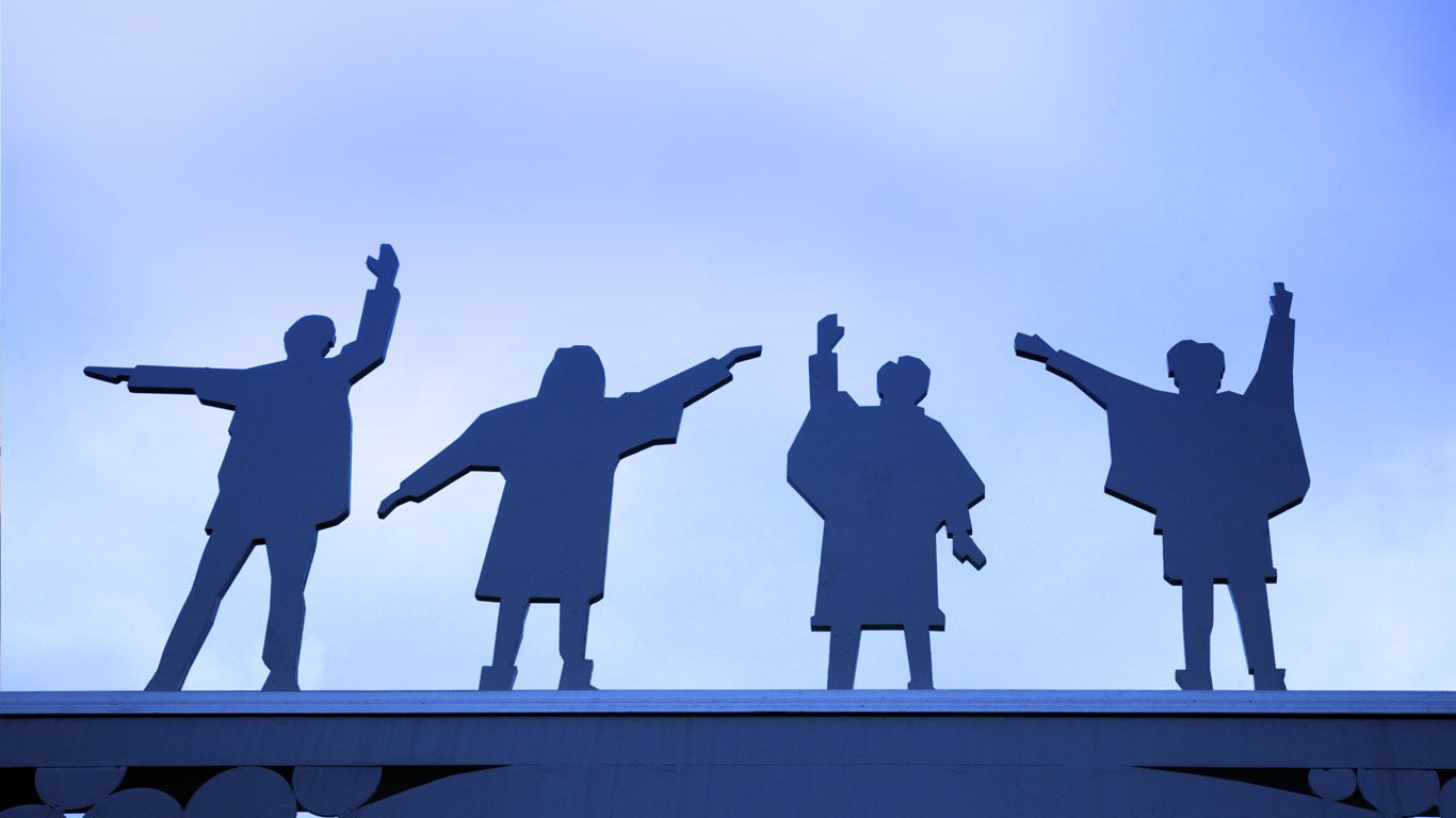 The Beatles depicted on a metal gate on Penny Lane, Liverpool, England