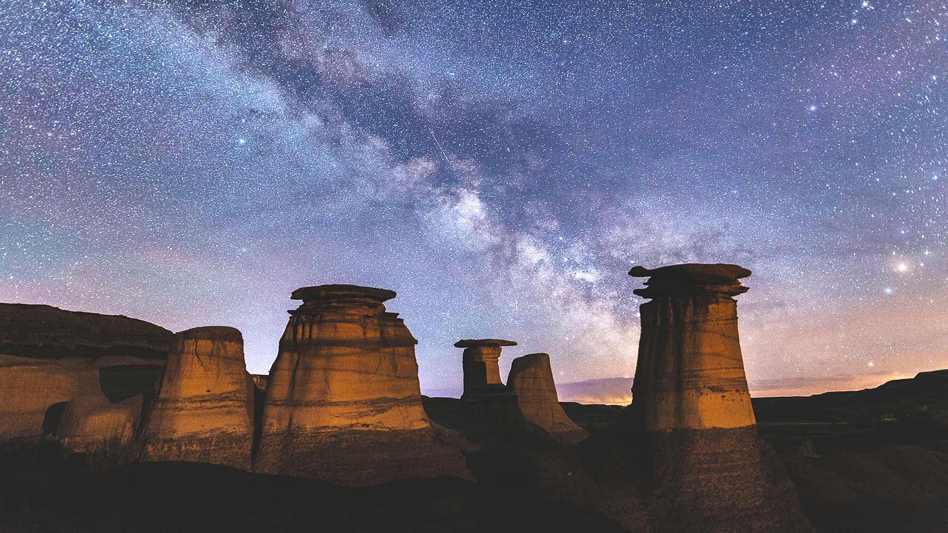 Milky Way over hoodoo rock formations in the Canadian Badlands, Drumheller, Alberta, Canada