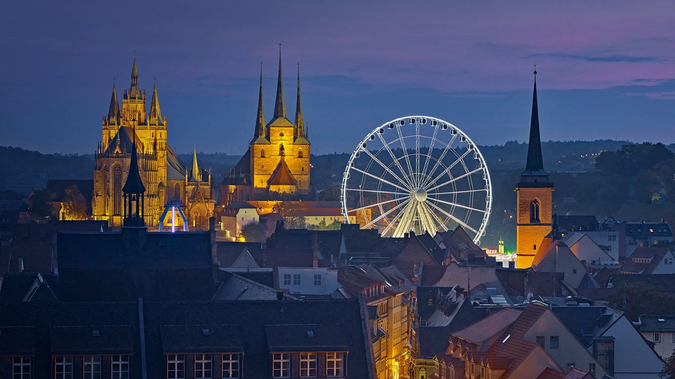 View of the Ferris wheel, Erfurt Cathedral and St. Severus Church during Oktoberfest in Erfurt, Germany