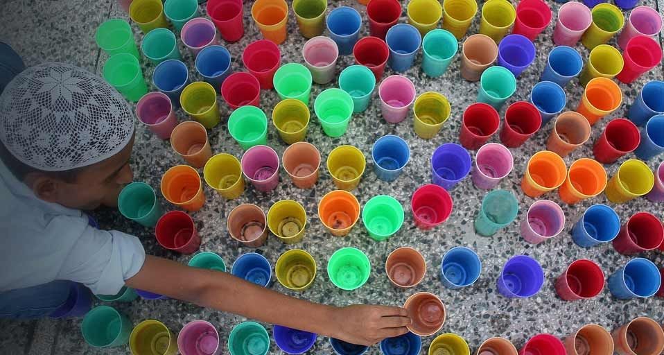 On the first day of Ramadan, a boy in India arranges glasses of water before Iftar, the meal Muslims eat to break their dawn-to-dusk fast