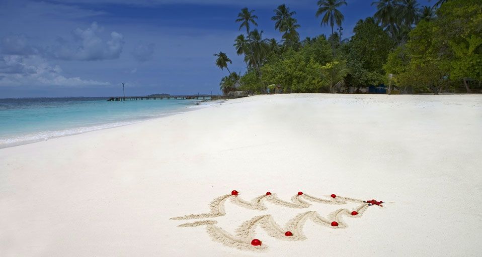 A Christmas tree outline drawn in the sand