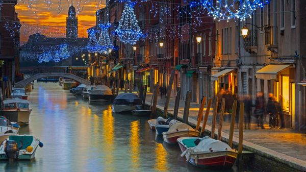 Festive decorations on a canal in Murano, Italy