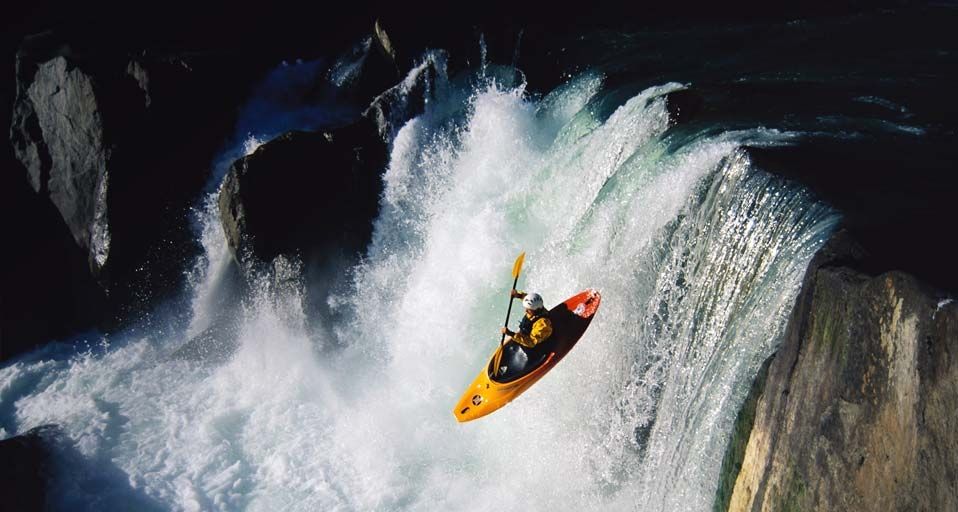 Whitewater kayaking over waterfall