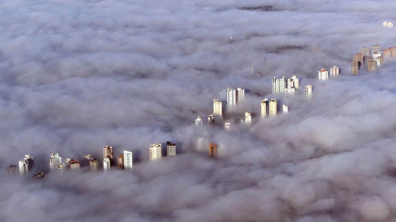 Aerial view of buildings enveloped by a thick fog in Curitiba, Brazil