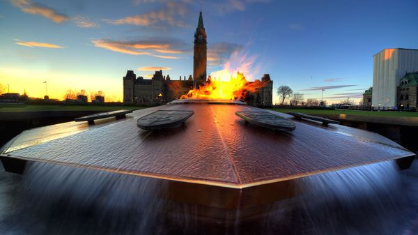 Parliament of Canada with eternal flame in foreground in Ottawa