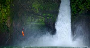 A man rappels down a huge cliff next to a waterfall on the Rio Alseseca in the state of Veracruz, Mexico -- Lucas Gilman/Aurora Photos &copy; (Bing New Zealand)