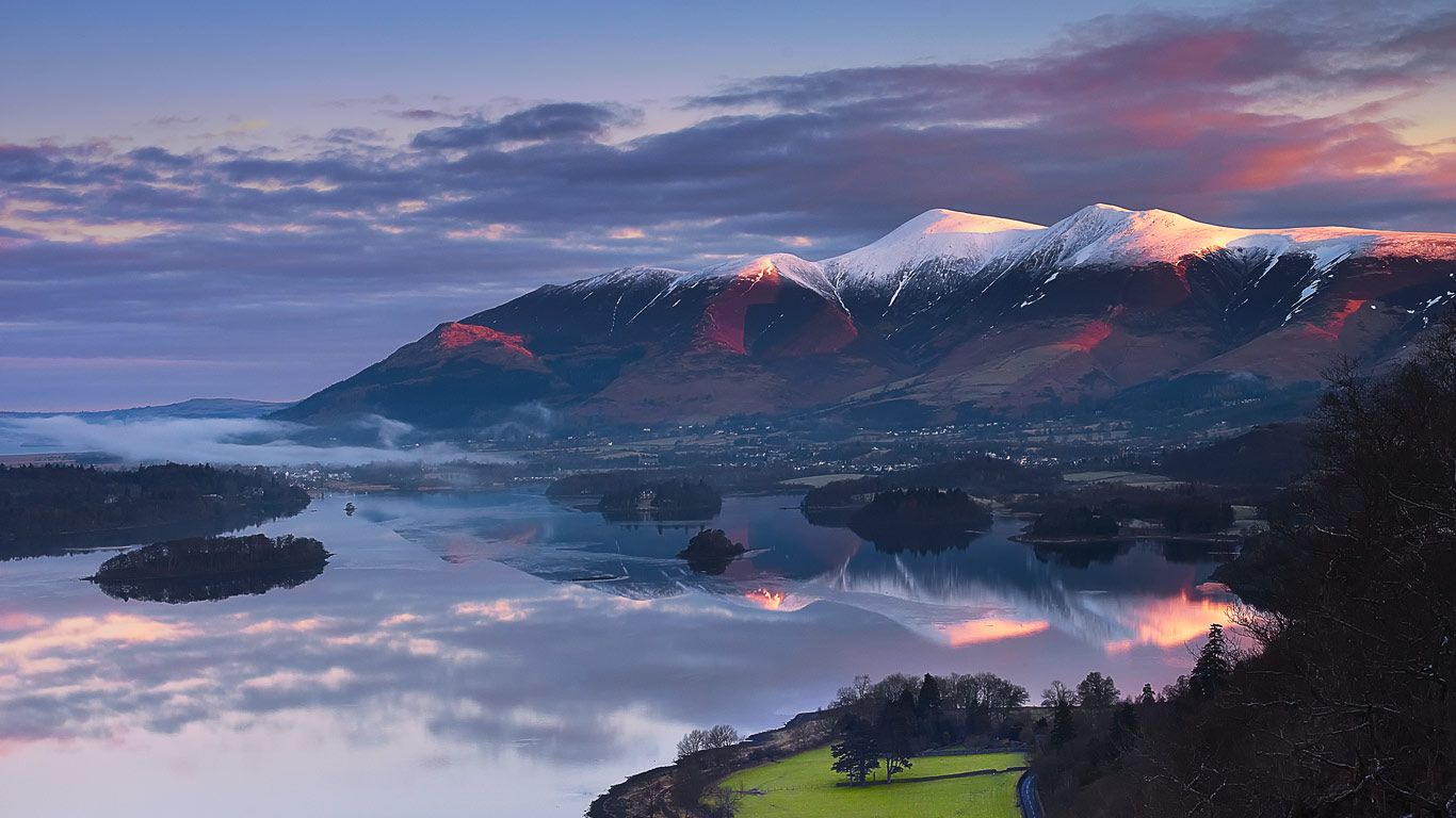 Sun rising over Skiddaw Mountain and Derwentwater in Cumbria, England