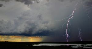 Lightning cracks in a cloud-filled sky with rain falling in distance, Kakadu National Park, Northern Territory, Australia -- Randy Olson/National Geographic/Getty Images &copy; (Bing Australia)
