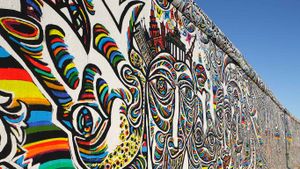 Shamil Gimajew’s ‘We Are A People’ on the renovated East Side Gallery of the Berlin Wall, Berlin, Germany (© Andreas Muhs/Agencja Fotograficzna Caro/Alamy)(Bing Australia)