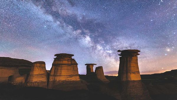 Milky Way over hoodoo rock formations in the Canadian Badlands, Drumheller, Alberta, Canada