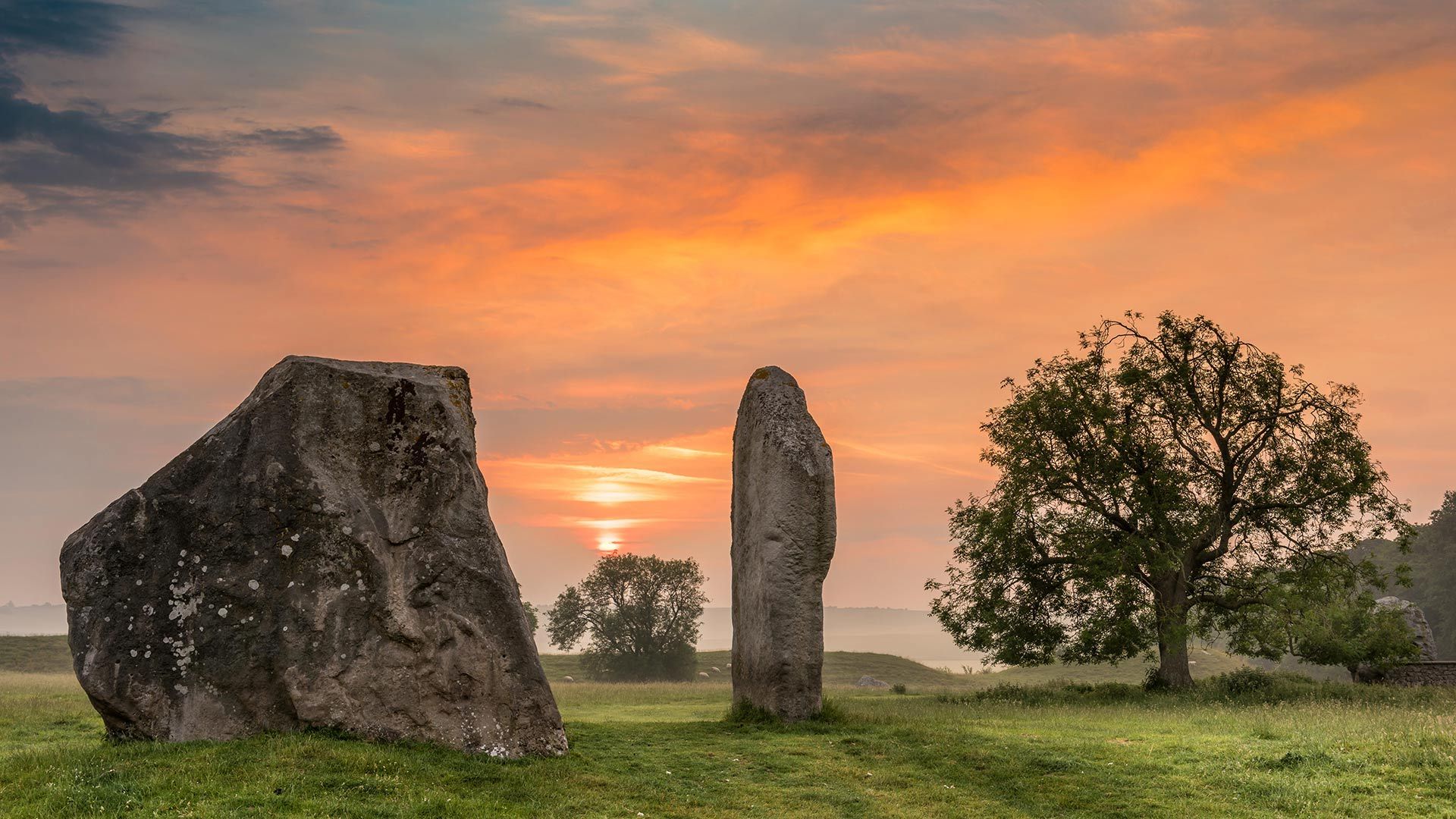 Dawn breaks over the ancient Sarsen Stones at Avebury, Wiltshire, at Summer Solstice