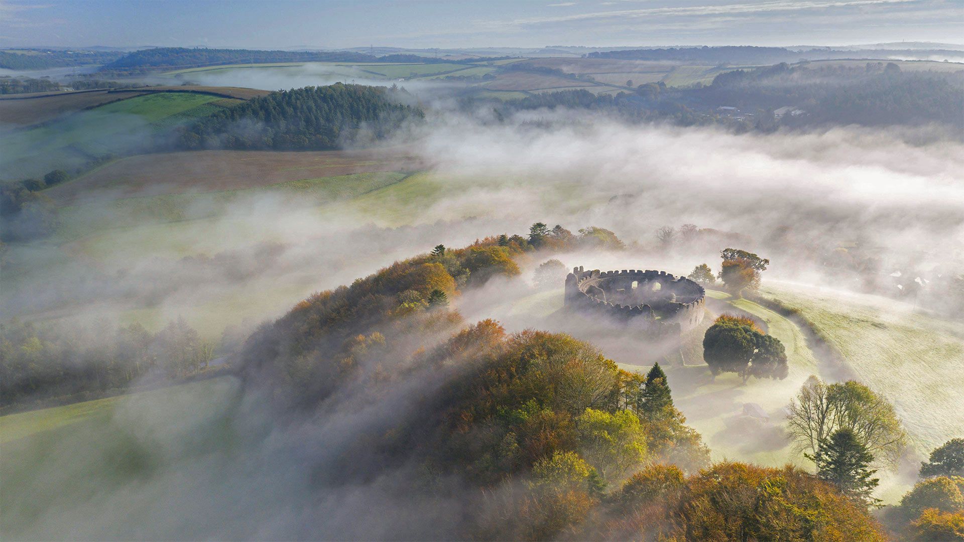 Autumn mist above Restormel Castle in Cornwall