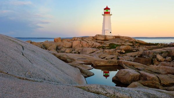 Lighthouse reflected in a pool of water at Peggy's Cove, N.S.
