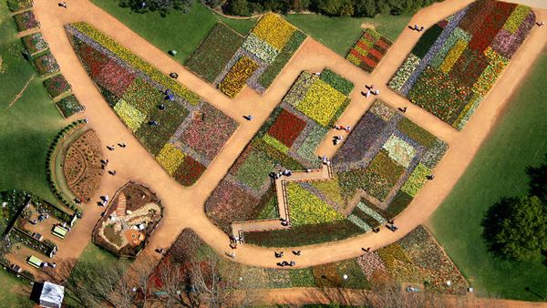 Tourists walk on pathways through a flowerbed design known as ‘The Australian Billabong’ at the Floriade flower festival in Canberra