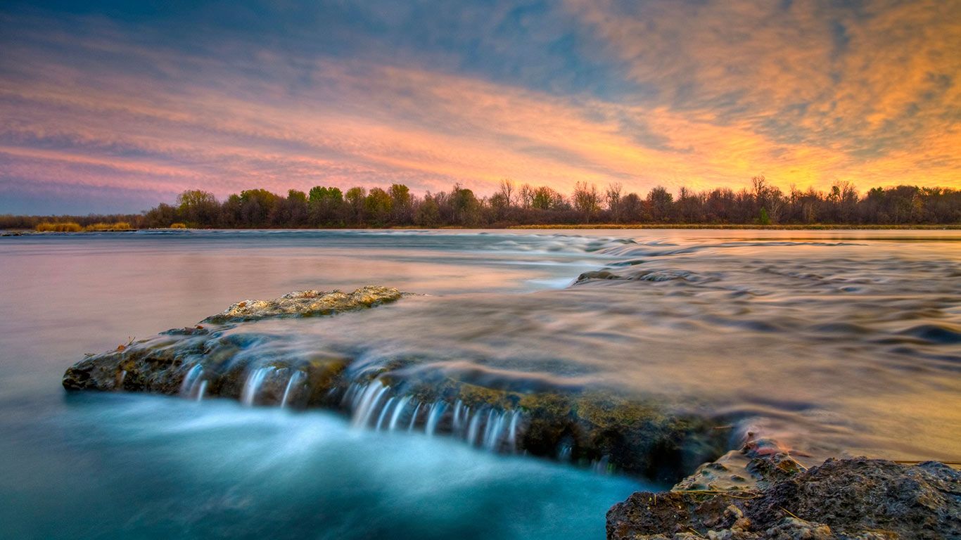 River flowing over rocks at twilight, Coteau-du-Lac, Que.