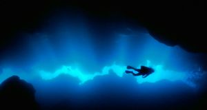 Diver in a grotto off of Roatan Island, Honduras -- Norbert Wu/Science Faction/Corbis &copy; (Bing New Zealand)