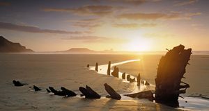 Sun setting over a shipwreck in the sand at Worm's Head on the Gower Peninsula © Joe Cornish/Britain on View Non-Exclusive/Photolibrary &copy; (Bing United Kingdom)