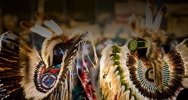 Two Native Americans wear elaborate costumes at a powwow in Post Falls, Idaho