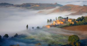 Early morning fog in Crete Senesi, Italy (© Fabio Muzzi/Corbis) &copy; (Bing Australia)