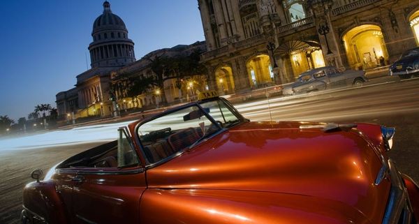 Vintage car with the Gran Teatro, El Capitolio in background, in Havana, Cuba