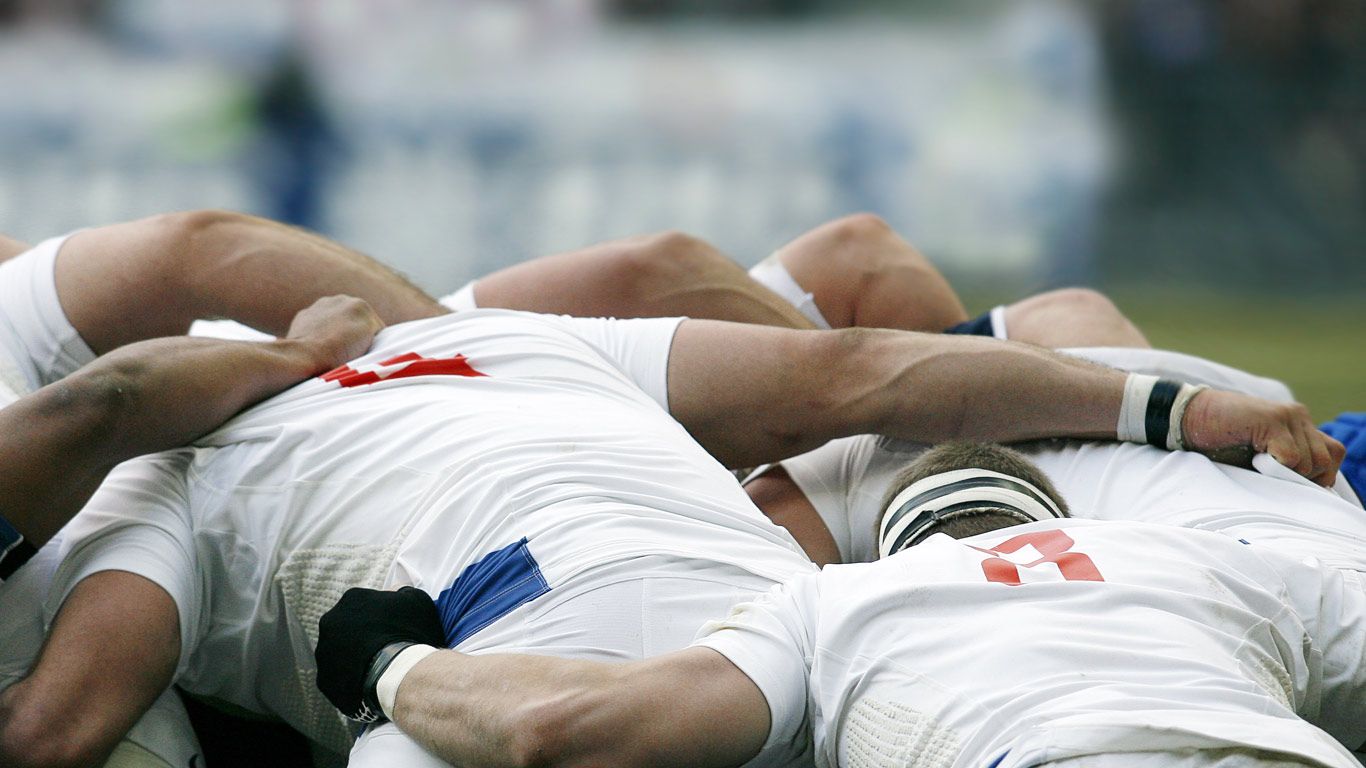 Rugby union players battle for the ball in a scrum