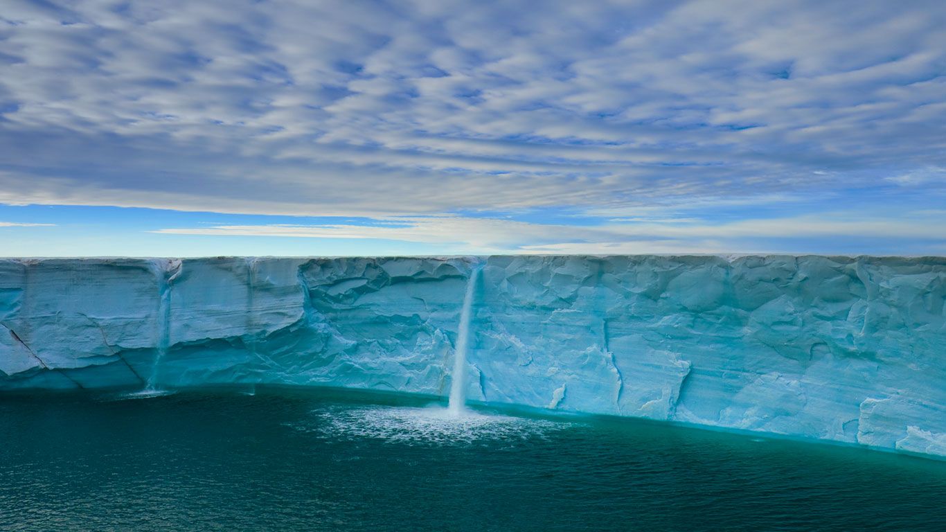 Meltwater creates waterfalls on an ice cap, Svalbard Archipelago, Norway