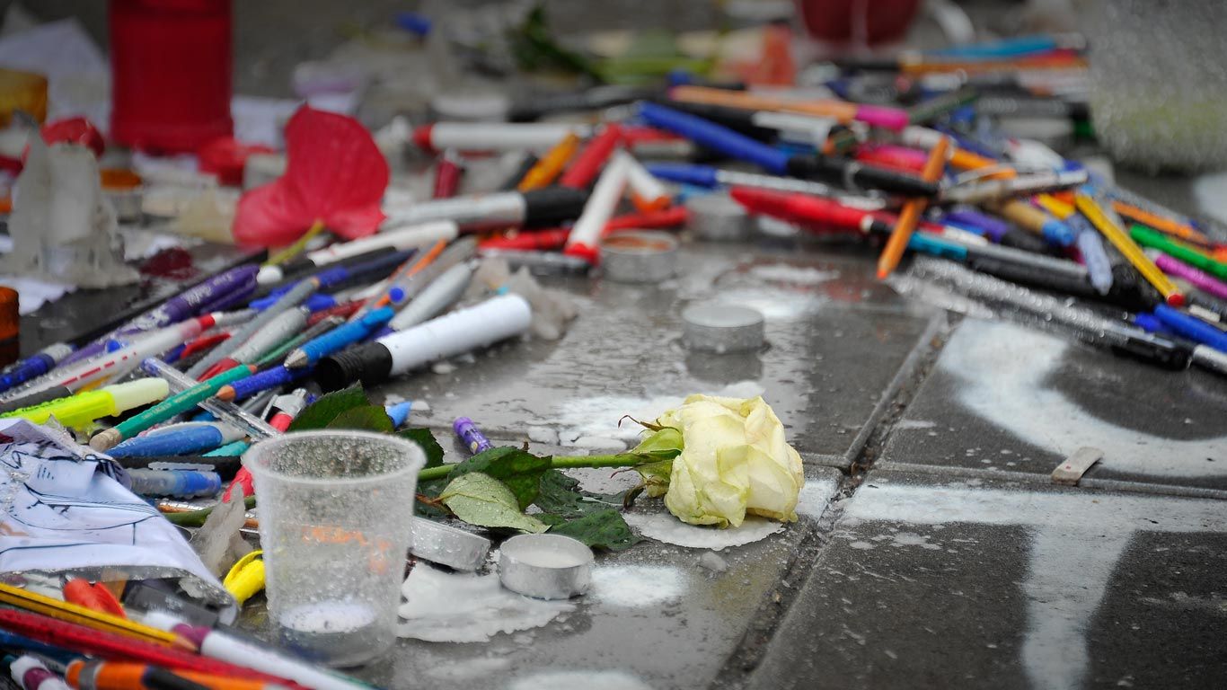 Tributes of candles, pens and flowers at Place de la Republique, Paris, France
