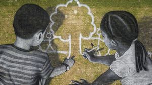 Artist Saype poses with his land art painting at UN Headquarters, Geneva, Switzerland (© Valentin Flauraud/EPA-EFE/Shutterstock)(Bing United States)