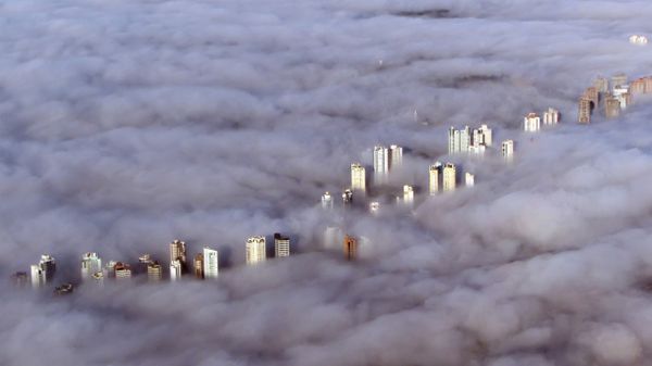 Aerial view of buildings enveloped by a thick fog in Curitiba, Brazil