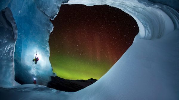 Climbing Athabasca Glacier in Jasper National Park, Alberta, Canada, as the Aurora Borealis glows