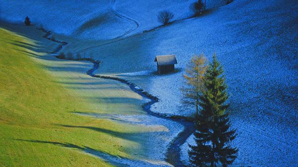Sun defrosts half a meadow in Tulfes, Austria
