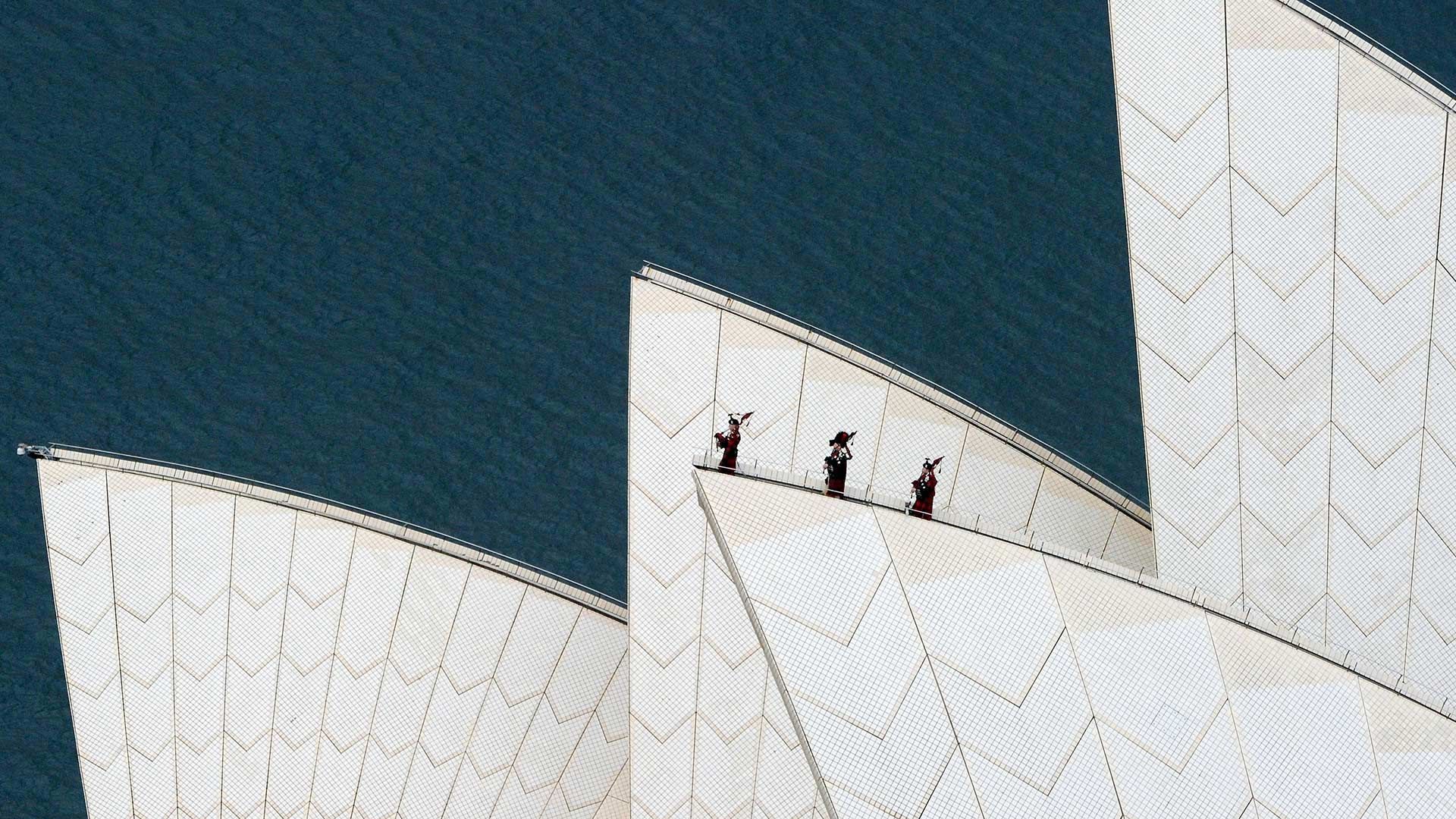 Royal Highland Fusiliers playing the bagpipes on top of the Sydney Opera House