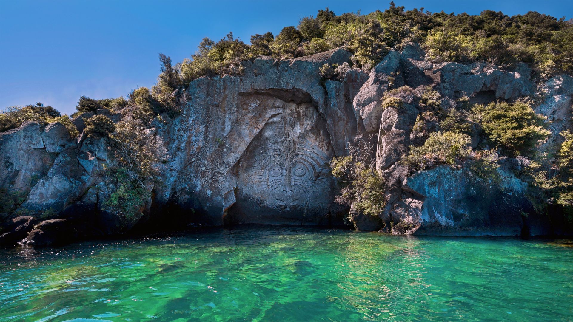 The Mine Bay Māori Rock Carving of Ngatoroirangi by Matahi Whakataka-Brightwell on the edge of Lake Taupo, North Island, New Zealand
