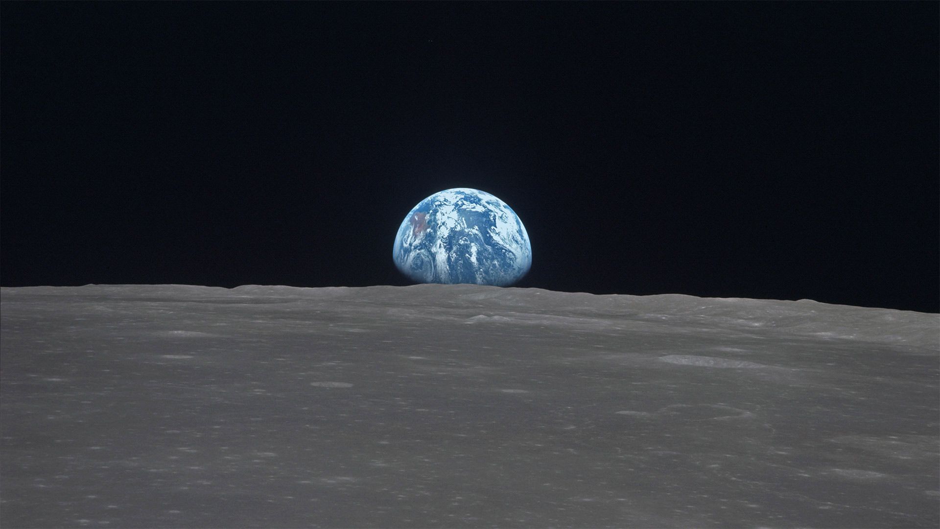 The Earth rises over Mare Smythii on the Moon